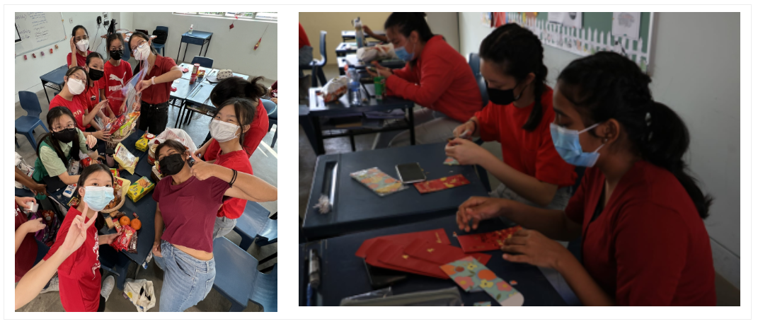TKGS students gathering around a table with snacks and gift hampers during a classroom activity. TKGS students creating and decorating red packets during a classroom craft activity.